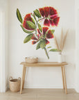 Floral wall mural in a room with a wooden table and decorative items.