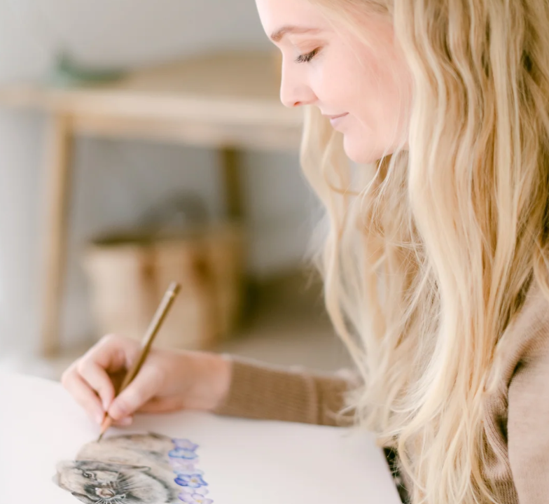 Olivia Bezett working on a coloured-pencil illustration