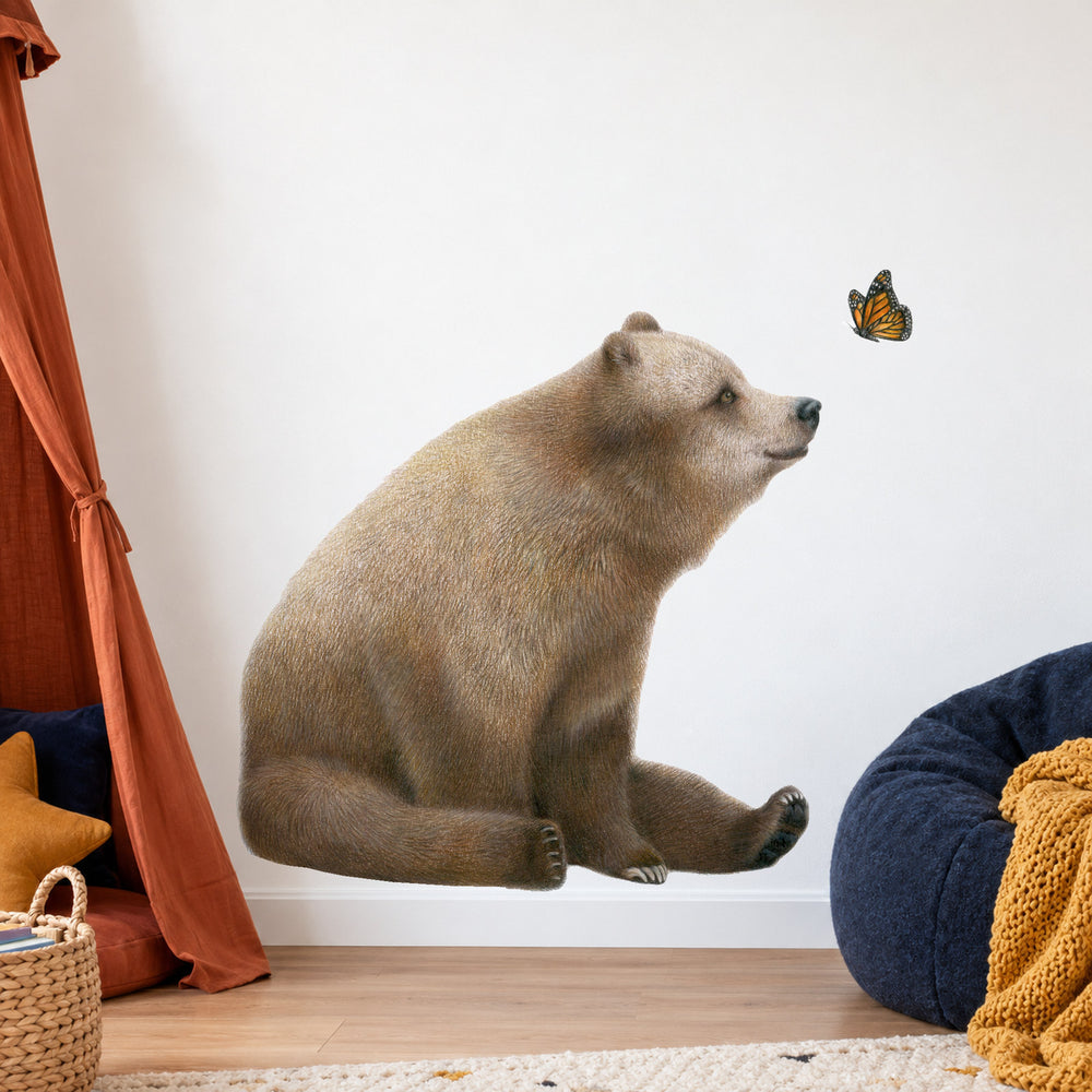 Bear and Butterfly by Olivia Bezett, wall decal room mock-up in a reading corner with a floor cushion.