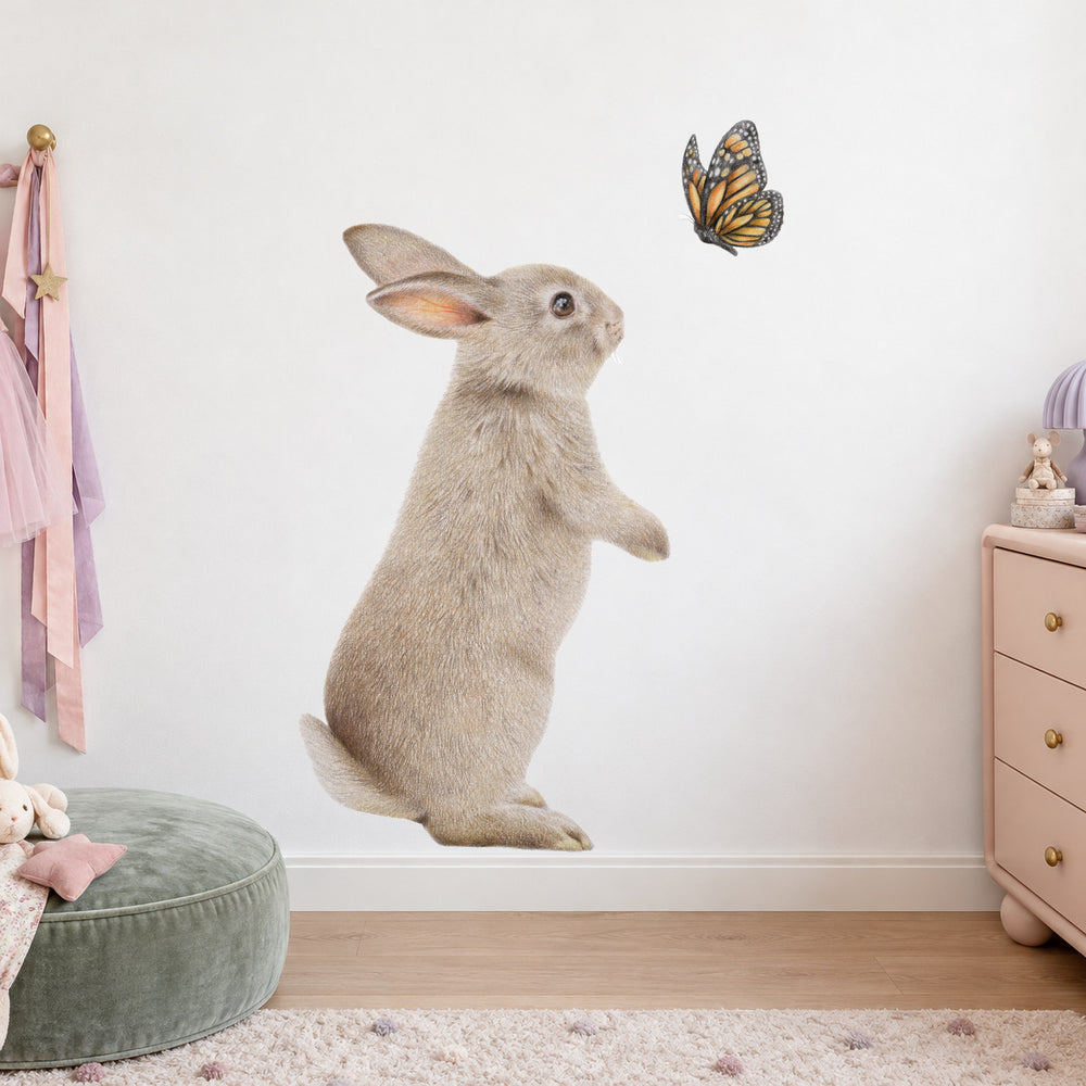Bunny and Butterfly by Olivia Bezett, wall decal room mock-up in a child’s bedroom beside pale pink furniture.