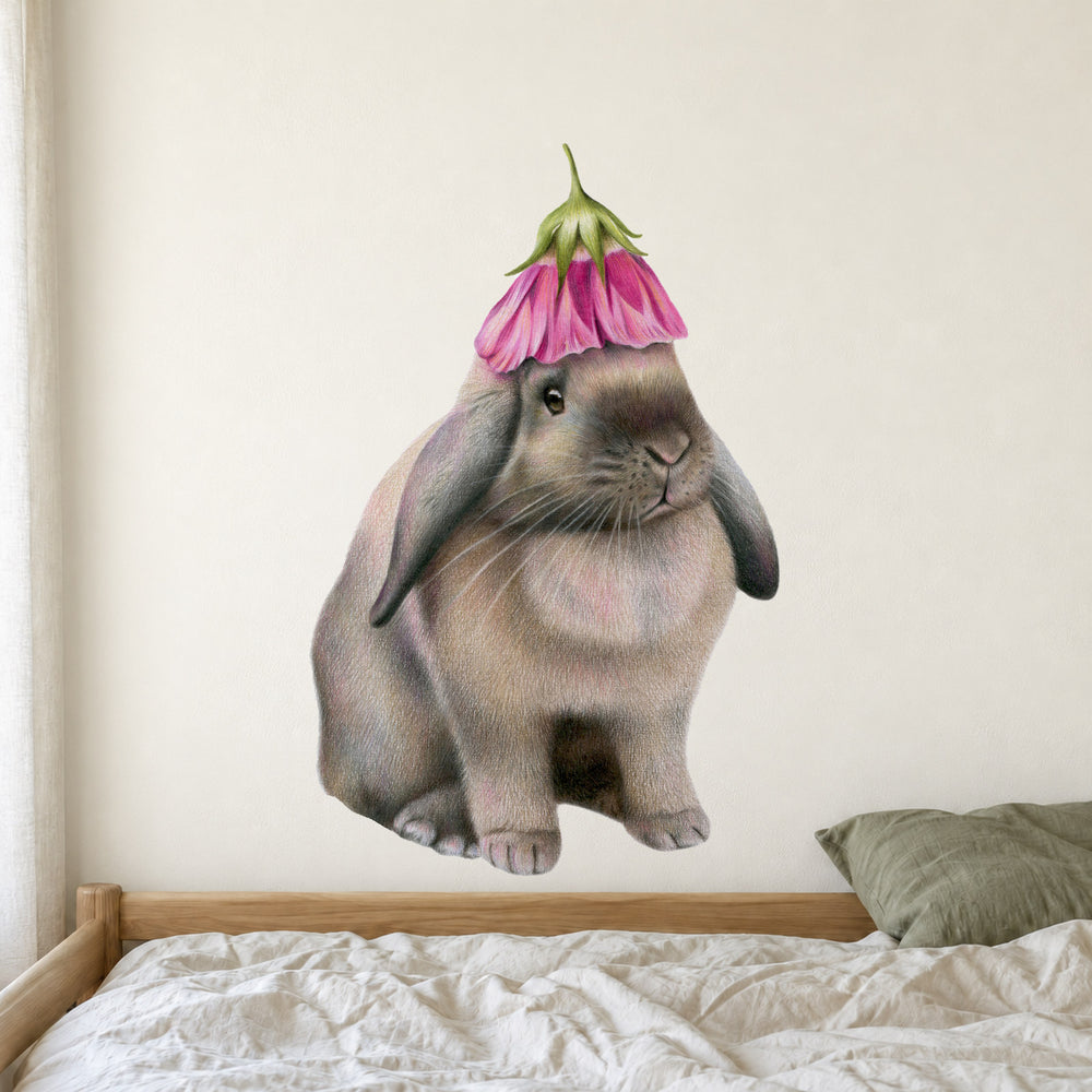 Rabbit with Flower Hat by Olivia Bezett, wall decal room mock-up in a bedroom above patterned bedding.