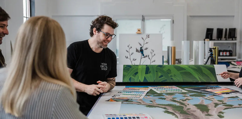 Antony discussing mural designs and colour options in the YDS Studio