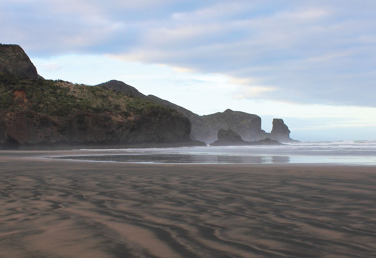 Antony and Jess walking bethells beach