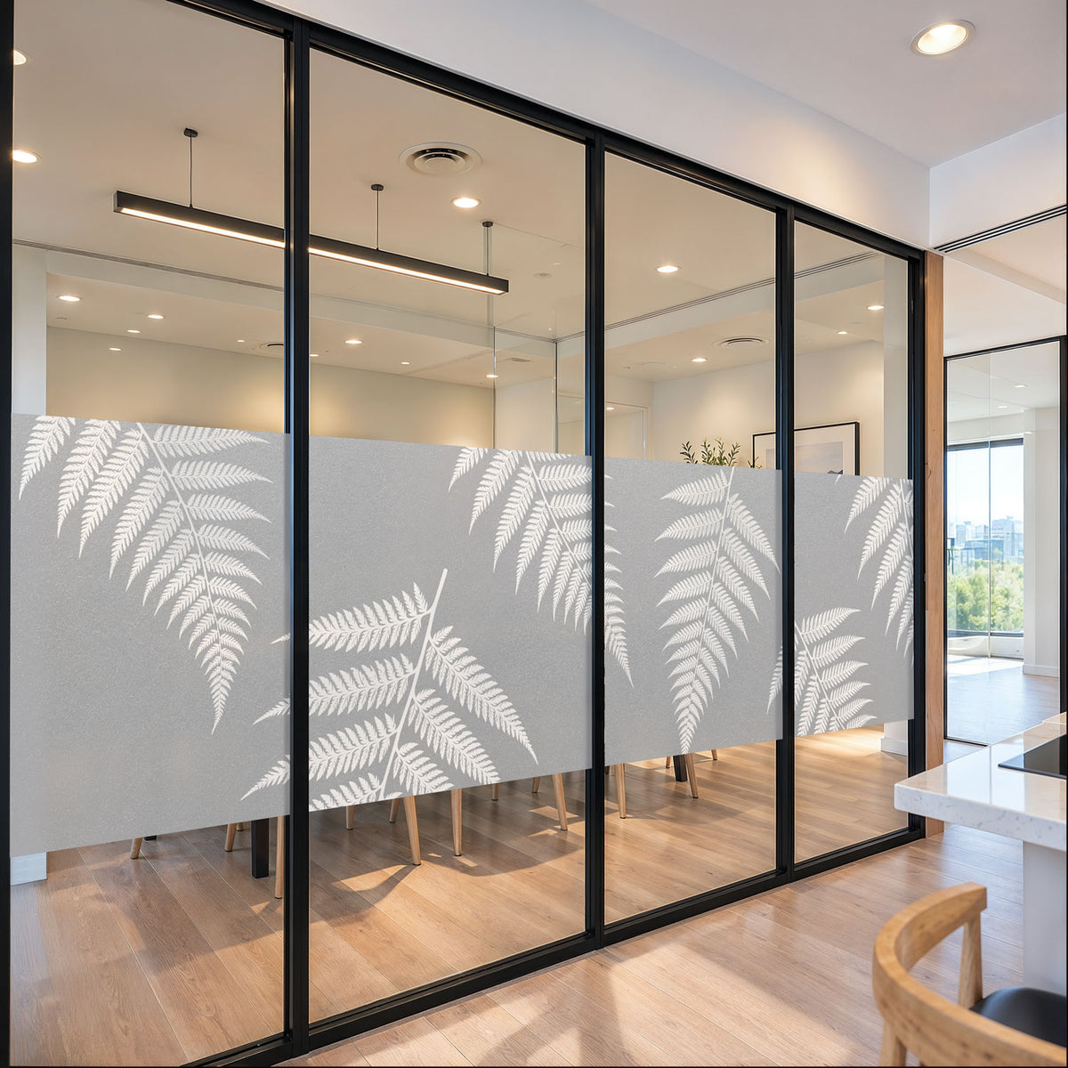 White native fern print on etched-look frosted vinyl across an office glass partition