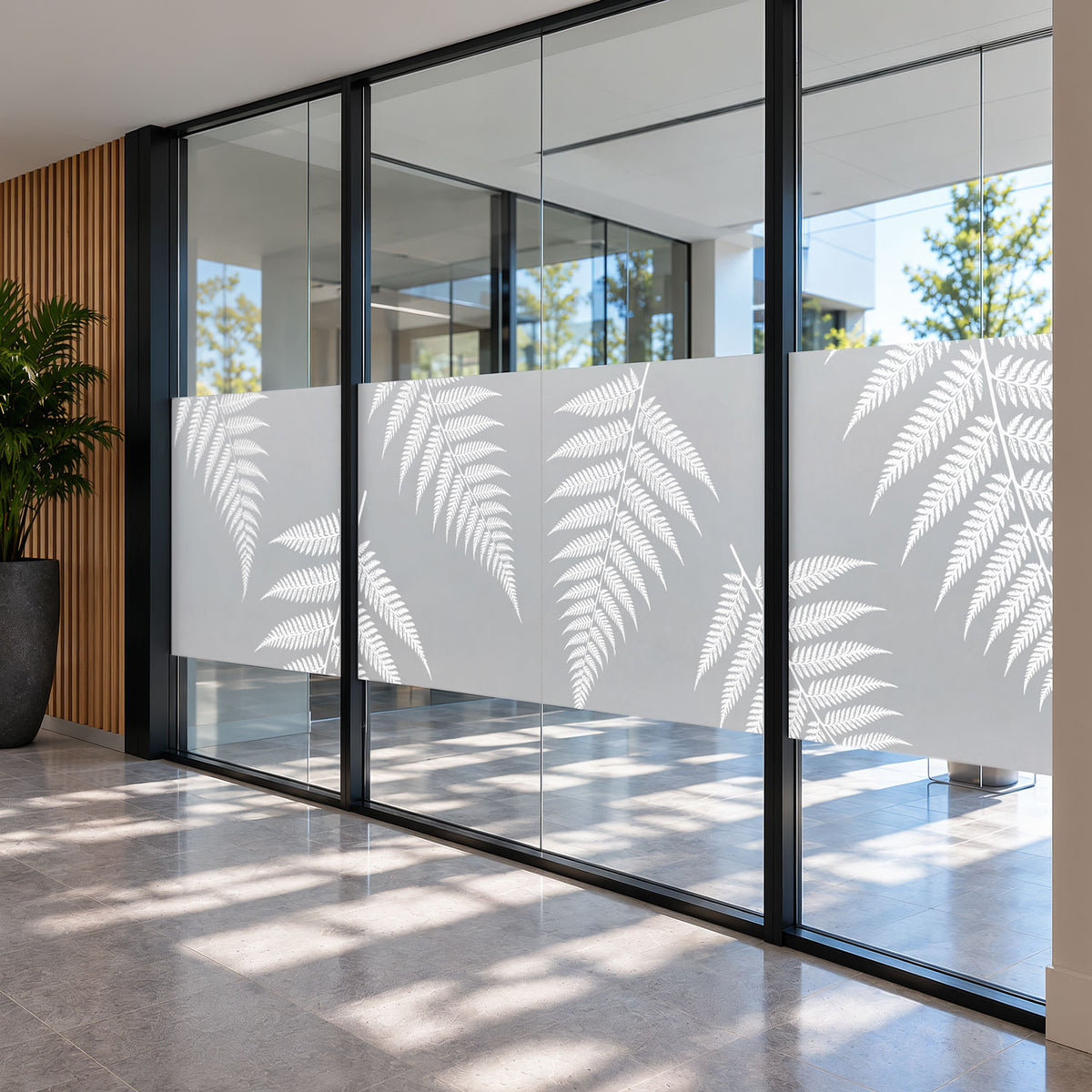 Native fern window frosting with white printed ferns across commercial glass entrance doors