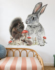 Bunny & Friends by Olivia Bezett, wall decal room mock-up in a child’s bedroom above a rattan headboard.