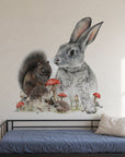 Bunny & Friends by Olivia Bezett, wall decal room mock-up in a room above a dark daybed.