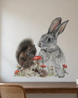 Bunny & Friends by Olivia Bezett, wall decal room mock-up in a room above a timber chest.