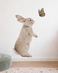 Bunny and Butterfly by Olivia Bezett, wall decal room mock-up in a child’s bedroom beside pale pink furniture.