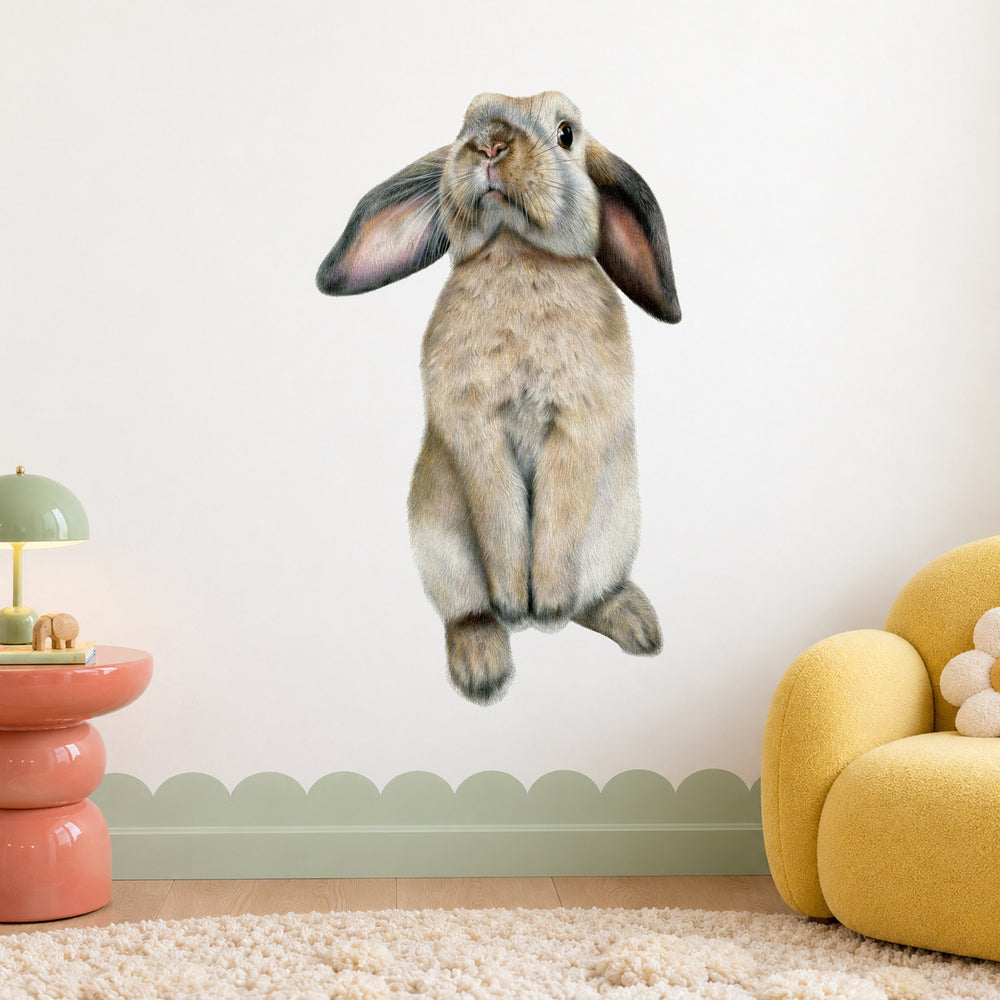 Curious Bunny by Olivia Bezett, wall decal room mock-up in a child’s room beside a yellow chair.
