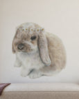 Daisy Bunny by Olivia Bezett, wall decal room mock-up in a child’s bedroom above a pale bed.