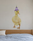 Duckling by Olivia Bezett, wall decal room mock-up in a bedroom above a timber bed.