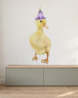 Duckling by Olivia Bezett, wall decal room mock-up in a living room above a low cabinet.