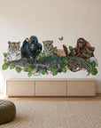 Jungle Friends by Olivia Bezett, wall mural room mock-up in a living room above a low timber cabinet.