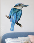 Kōtare by Olivia Bezett, wall decal room mock-up in a bedroom above blue bedding.