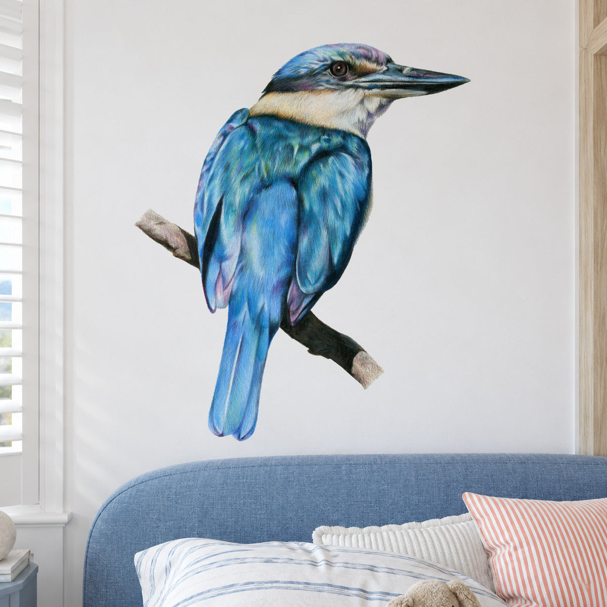 Kōtare by Olivia Bezett, wall decal room mock-up in a bedroom above blue bedding.