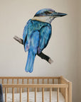 Kōtare by Olivia Bezett, wall decal room mock-up in a nursery above a timber cot.