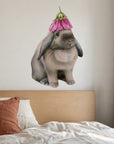 Rabbit with Flower Hat by Olivia Bezett, wall decal room mock-up in a bedroom above a timber headboard.