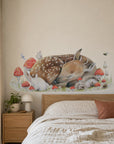 Sleeping Doe by Olivia Bezett, wall decal room mock-up in a bedroom above a timber headboard.