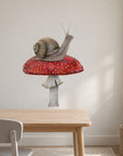 Snail on Mushroom by Olivia Bezett, wall decal room mock-up in a study above a pale timber table.