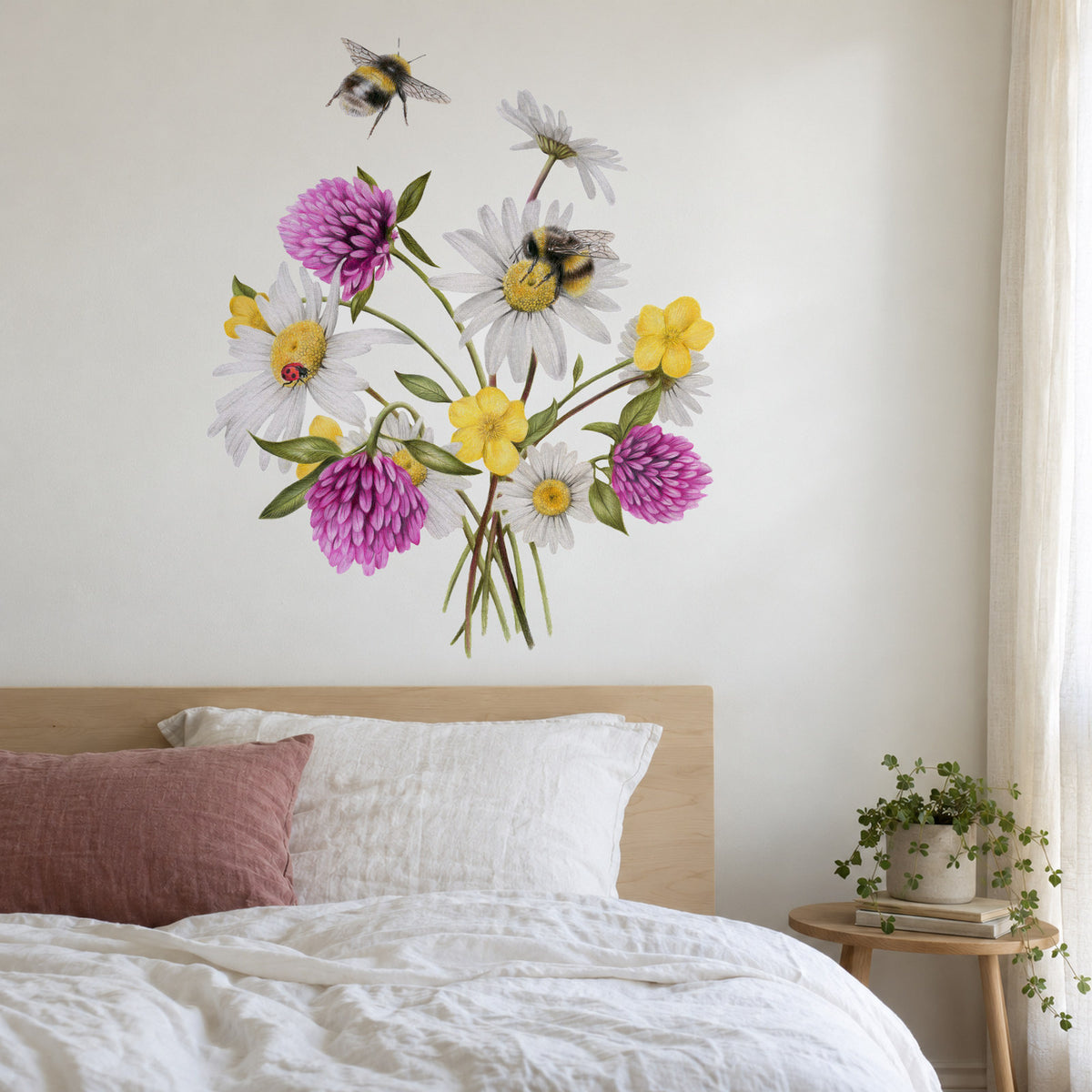 Wildflower Bees by Olivia Bezett, wall decal room mock-up in a bedroom above a pale pink headboard.