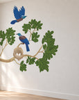 Tūī nest and leafy branch wall decal in a bright designer room, view 2.