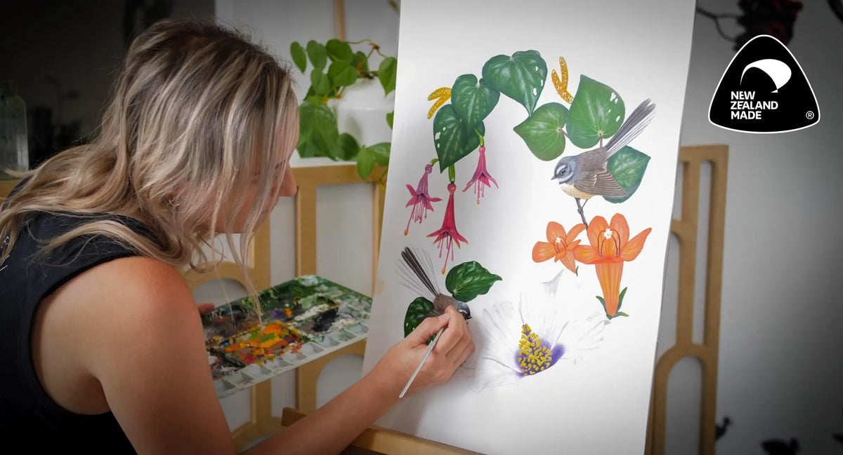 Shayla carefully removing the surrounding material from a sheet of printed botanical decals