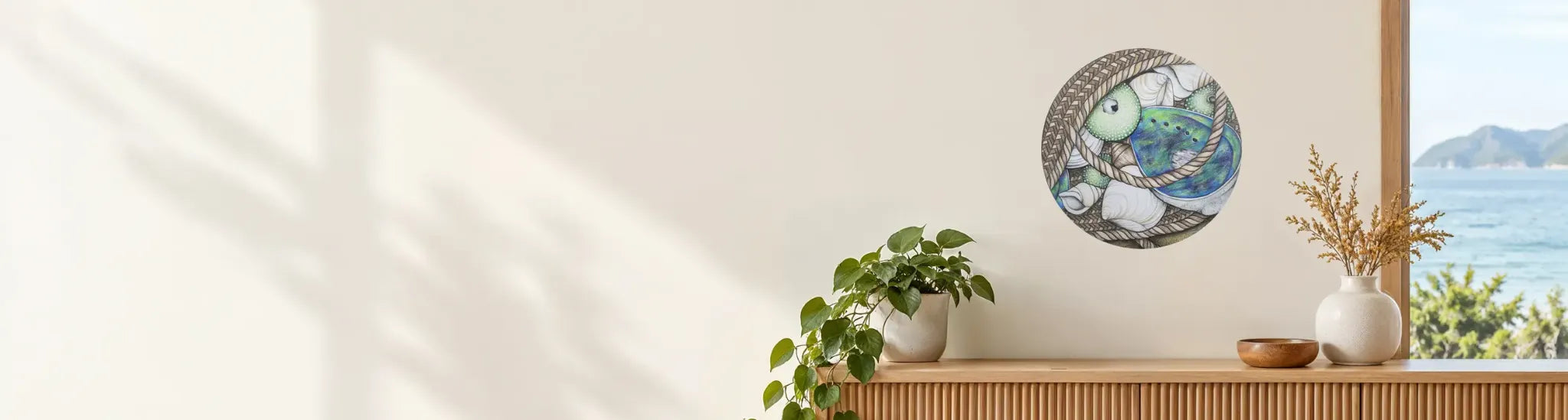Pāua Shells and Kete decal displayed on a wall in a coastal New Zealand room