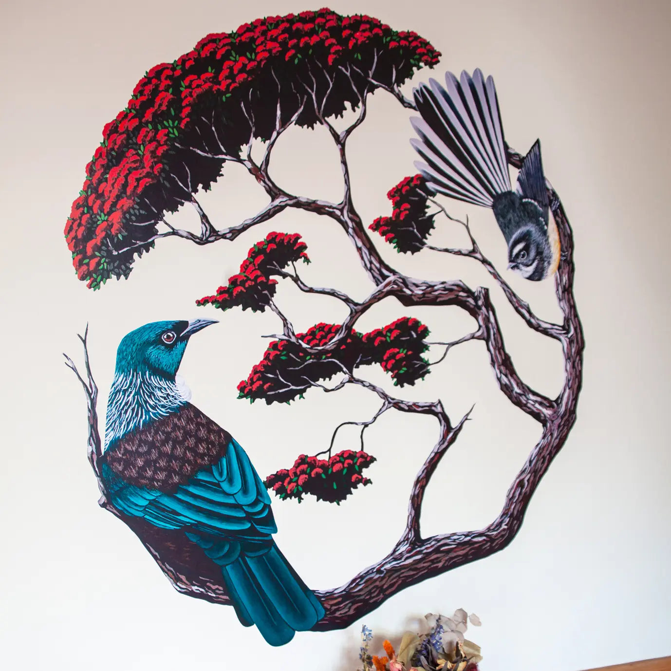 Tui and fantail wall decal in pohutukawa shown on a wall